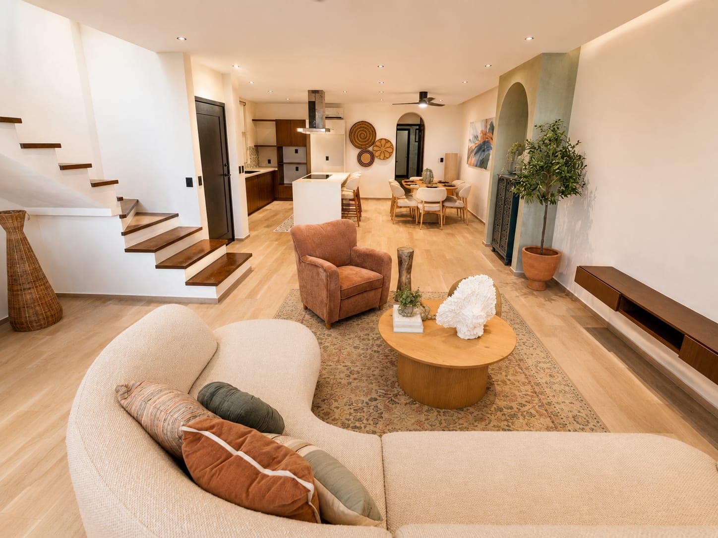 Estancia del penthouse Edúlis, con la escalera al nivel de arriba